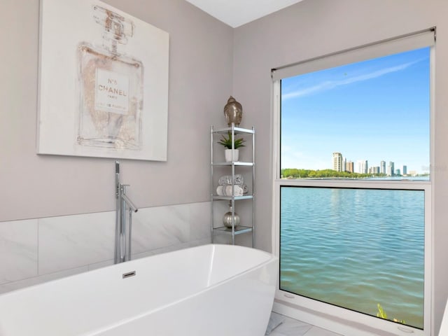 2807 W Hawthorne Rd Unit 11, Tampa, FL 33611 - full bathroom featuring a freestanding tub, a view of city, and marble finish floors