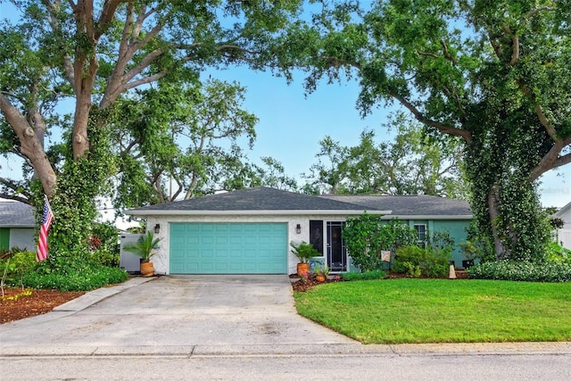 single story home featuring concrete driveway, a garage, a front yard, and stucco siding