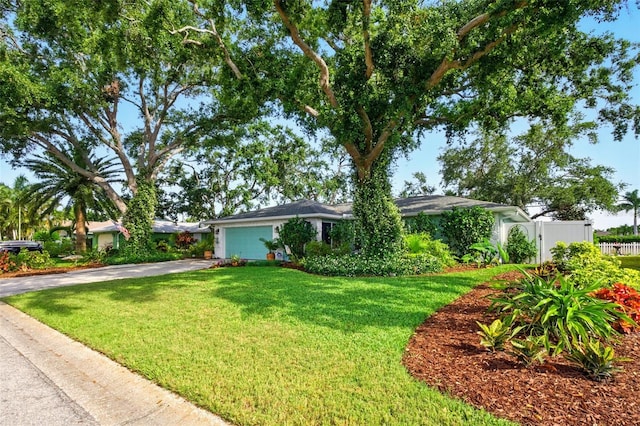 ranch-style house featuring asphalt driveway