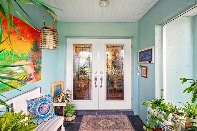 doorway to property with french doors and stucco siding