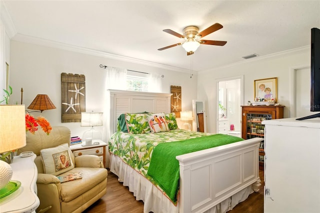 bedroom with wood finished floors, ornamental molding, and ceiling fan