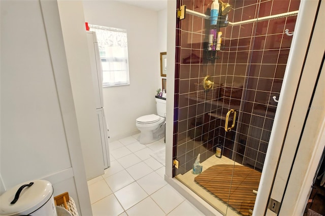 bathroom with toilet, tile patterned flooring, and a stall shower