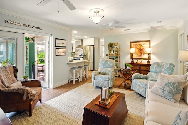 living area with ceiling fan, ornamental molding, light wood-style flooring, baseboards, and recessed lighting