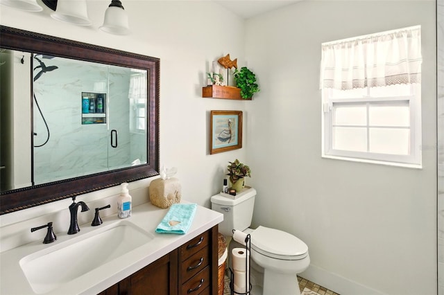 bathroom featuring plenty of natural light, a marble finish shower, toilet, and vanity