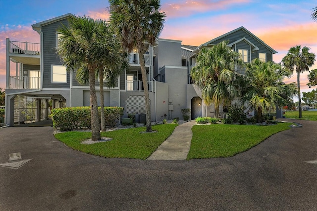 5712 Biscayne Ct Unit 103, New Port Richey, FL 34652 - view of front of property with a carport, stucco siding, and a front yard