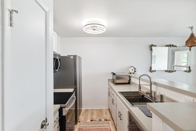 5712 Biscayne Ct Unit 103, New Port Richey, FL 34652 - kitchen featuring electric range, a sink, white cabinets, and light countertops