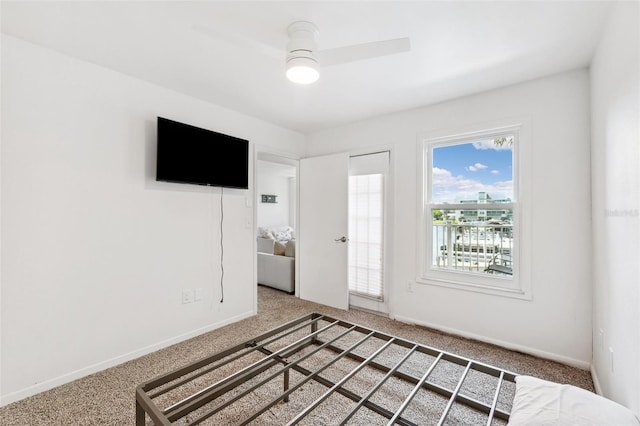 5712 Biscayne Ct Unit 103, New Port Richey, FL 34652 - unfurnished bedroom with carpet flooring, baseboards, and a ceiling fan