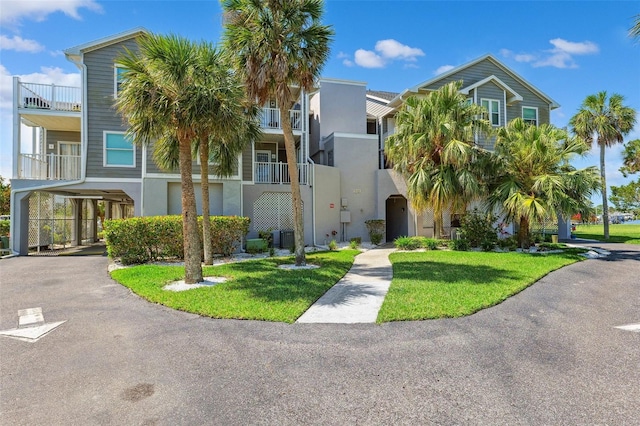 5712 Biscayne Ct Unit 103, New Port Richey, FL 34652 - view of property featuring a carport and driveway