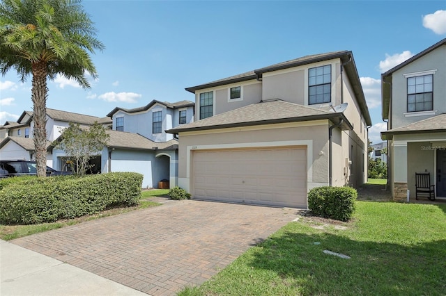 1119 Ballard Green Pl, Brandon, FL 33511 - view of front of property featuring an attached garage, decorative driveway, stucco siding, and a front yard