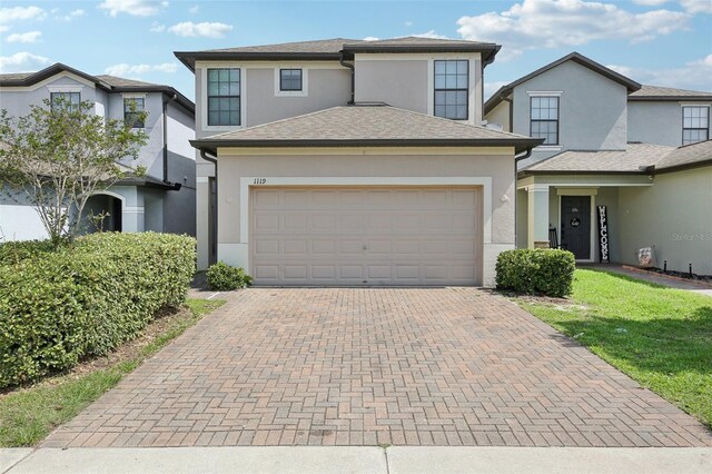 1119 Ballard Green Pl, Brandon, FL 33511 - view of front of home featuring stucco siding, decorative driveway, and a garage