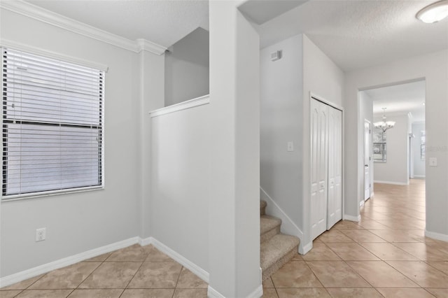 1119 Ballard Green Pl, Brandon, FL 33511 - hall featuring a chandelier, light tile patterned floors, ornamental molding, baseboards, and stairway