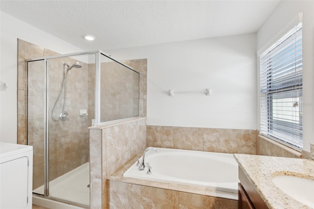 1119 Ballard Green Pl, Brandon, FL 33511 - bathroom featuring a shower stall, vanity, a garden tub, washer / clothes dryer, and a textured ceiling