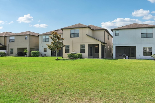 1119 Ballard Green Pl, Brandon, FL 33511 - rear view of property with stucco siding and a lawn