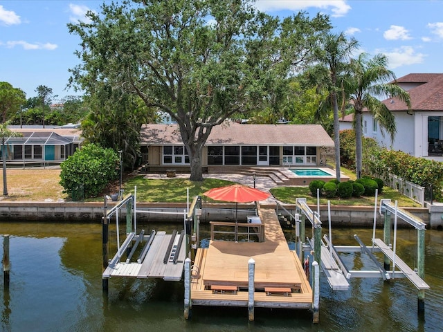 dock featuring boat lift, a water view, and an outdoor pool