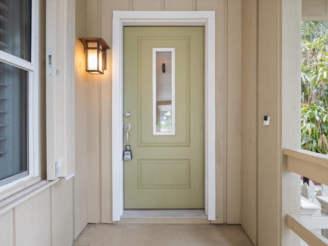 property entrance featuring board and batten siding