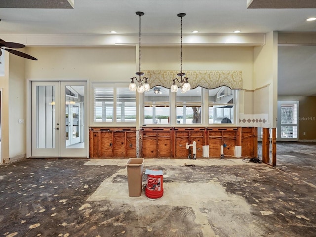 kitchen with a ceiling fan, a chandelier, pendant lighting, and french doors