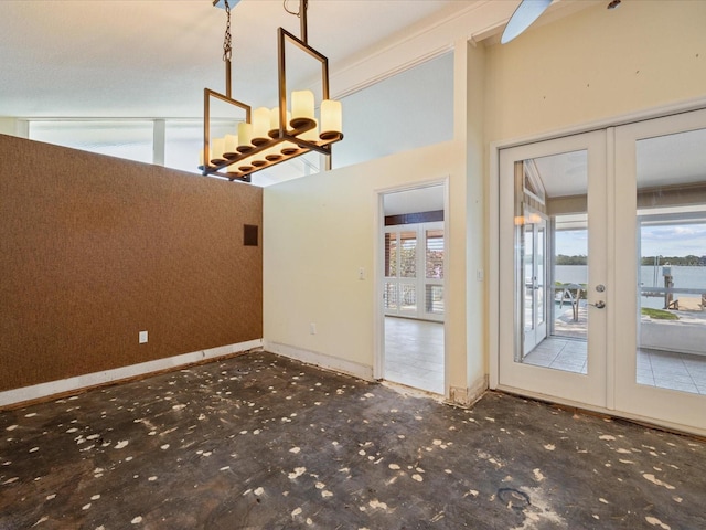 unfurnished dining area featuring french doors and baseboards
