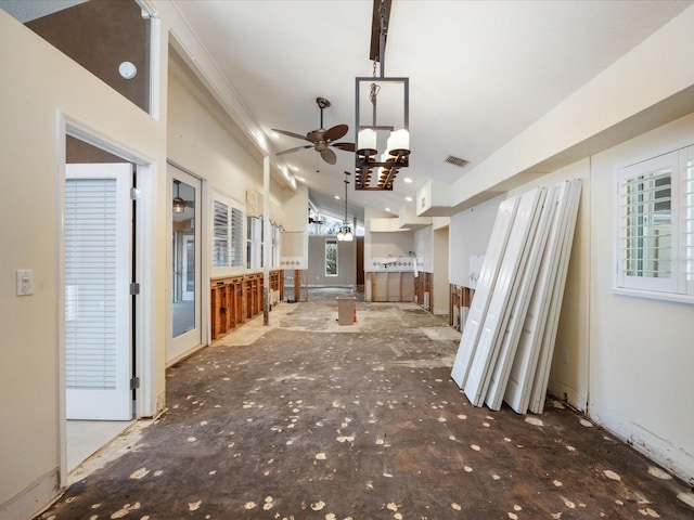 unfurnished living room featuring a ceiling fan and crown molding