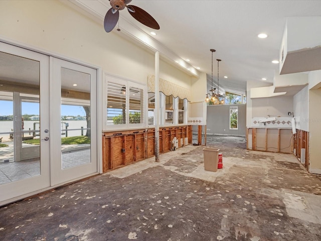unfurnished living room featuring a water view, ceiling fan, and recessed lighting