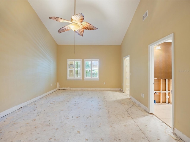 spare room with ceiling fan and high vaulted ceiling