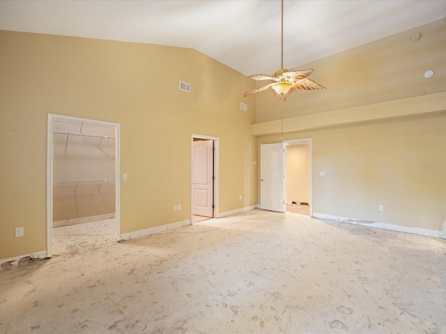 spare room featuring high vaulted ceiling, ceiling fan, and baseboards