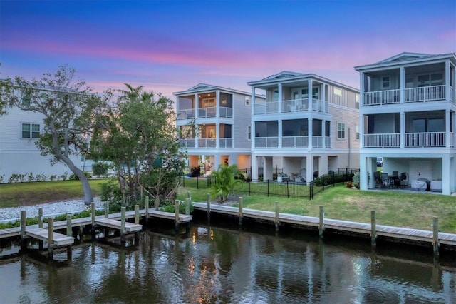 back of property featuring a water view and a patio