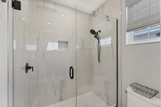 full bath with toilet and a stall shower
