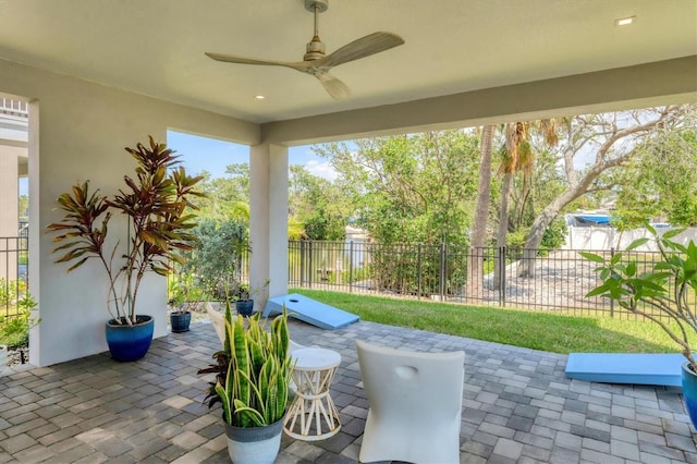 view of patio / terrace featuring fence and a ceiling fan