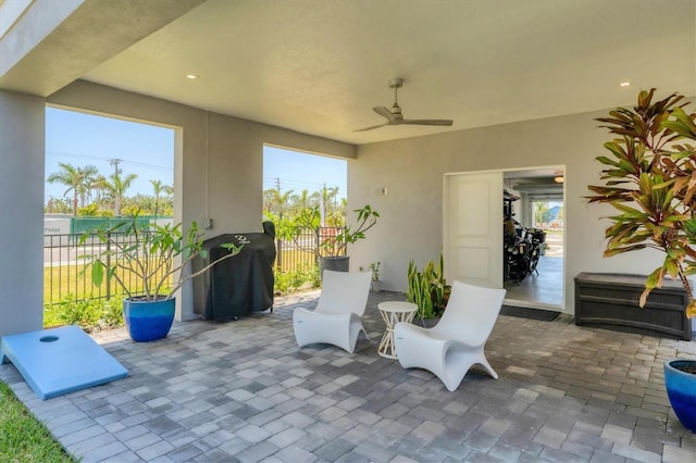 view of patio / terrace with fence, ceiling fan, and area for grilling