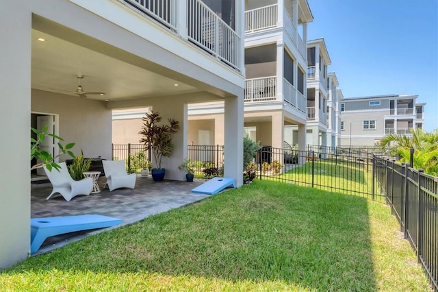 view of yard with a ceiling fan and a patio