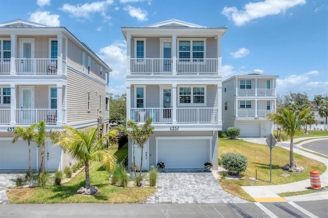 4357 Marina View Way, Cortez, FL 34215 - coastal inspired home with an attached garage, driveway, and a balcony