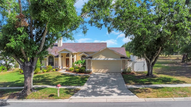 single story home with an attached garage, a front yard, driveway, a chimney, and stucco siding