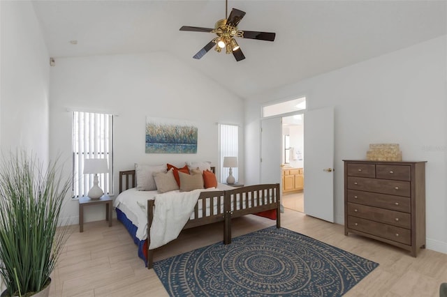 bedroom featuring high vaulted ceiling, ensuite bath, and ceiling fan