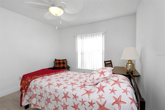 bedroom featuring ceiling fan and baseboards