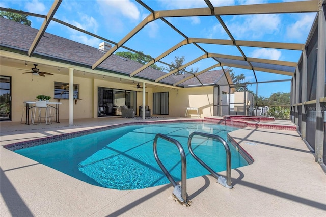 view of pool with ceiling fan, a patio, a pool with connected hot tub, and a lanai