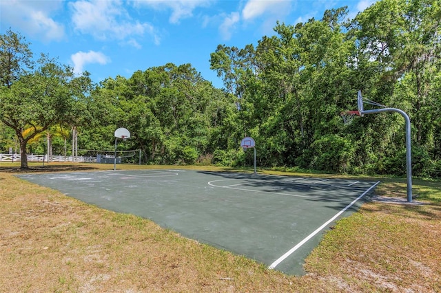view of basketball court featuring community basketball court and a yard