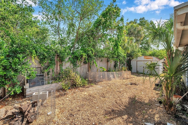 3621 Beacon Square Dr, Holiday, FL 34691 - fenced backyard featuring a storage shed and an outbuilding