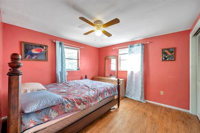3621 Beacon Square Dr, Holiday, FL 34691 - bedroom with wood finished floors, baseboards, a closet, and a ceiling fan