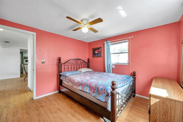 3621 Beacon Square Dr, Holiday, FL 34691 - bedroom featuring light wood-style flooring, baseboards, and a ceiling fan