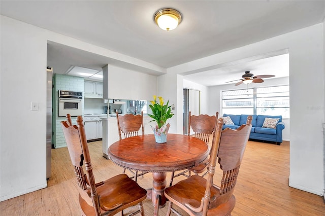 3621 Beacon Square Dr, Holiday, FL 34691 - dining space featuring a ceiling fan and light wood-style flooring