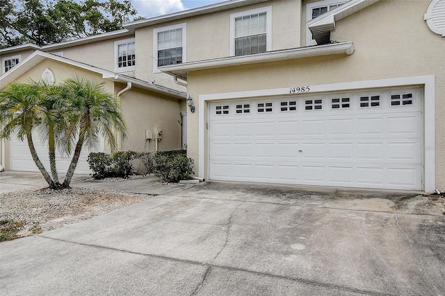 14985 Alan Ct, Largo, FL 33771 - view of front facade with stucco siding and concrete driveway