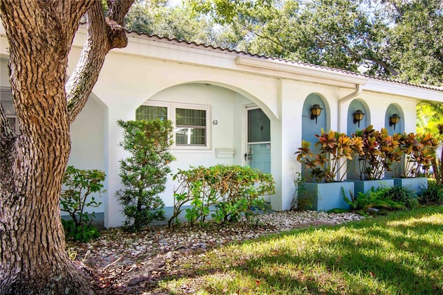 property entrance with stucco siding