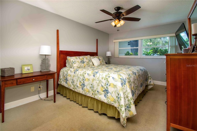 bedroom featuring carpet, baseboards, and a ceiling fan