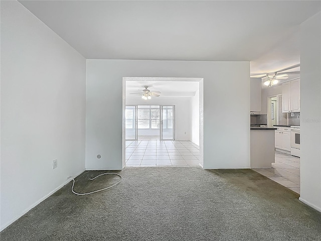 904 Desert Hills Dr, Sun City Center, FL 33573 - spare room with ceiling fan, light carpet, and light tile patterned floors