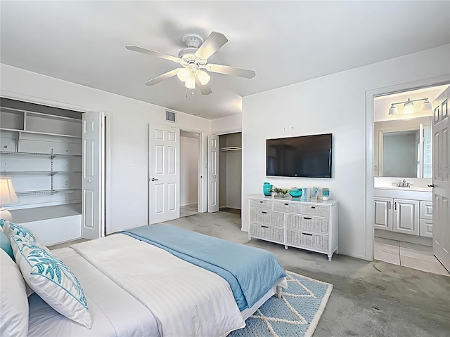 904 Desert Hills Dr, Sun City Center, FL 33573 - bedroom with two closets, a ceiling fan, and ensuite bathroom