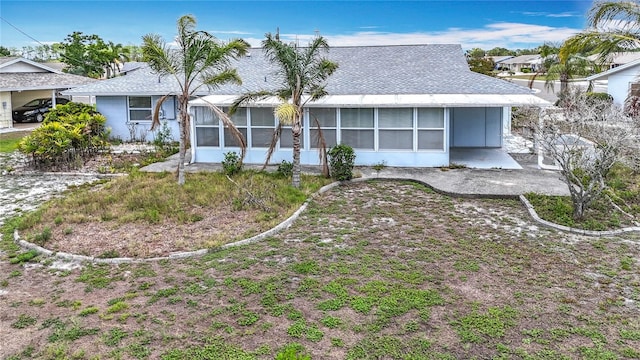 904 Desert Hills Dr, Sun City Center, FL 33573 - view of front of house featuring a sunroom and roof with shingles