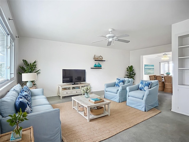 904 Desert Hills Dr, Sun City Center, FL 33573 - living area featuring a ceiling fan, healthy amount of natural light, and concrete flooring