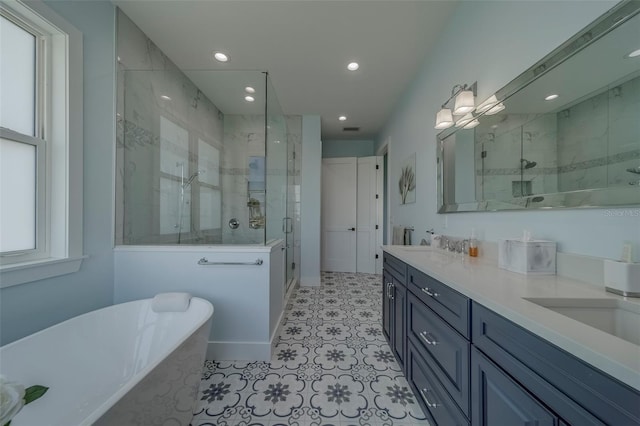 15805 Redington Dr, Redington Beach, FL 33708 - full bath with a stall shower, double vanity, a soaking tub, recessed lighting, and baseboards