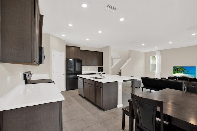 10379 Bridgegate Heights Loop, San Antonio, FL 33576 - kitchen with stove, freestanding refrigerator, dark brown cabinetry, a sink, and dishwasher
