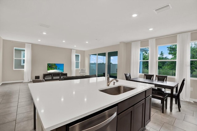 10379 Bridgegate Heights Loop, San Antonio, FL 33576 - kitchen with a sink, light tile patterned flooring, dishwasher, plenty of natural light, and recessed lighting